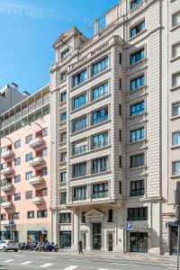 a large building on a city street with a street at Hotel Via Augusta in Barcelona