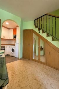 an empty kitchen with a staircase in a house at El rincón de Arévalo in Arévalo +22 photos