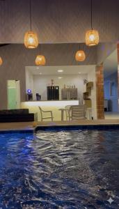 a swimming pool with water in the middle of a house at Chácara encantos Iranduba in Iranduba