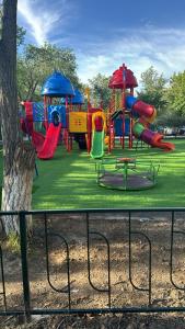 a park with a playground with a slide at квартира жубанова in Aktobe