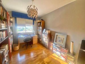a living room with a desk and bookshelves at Terra marina in Grao de Castellón