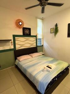 a bedroom with a bed with a ceiling at Art Villa in Alor Setar