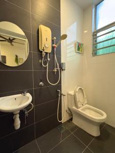 a bathroom with a shower and a toilet and a sink at Art Villa in Alor Setar