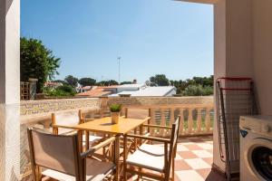a table and chairs on a balcony with a view at Las Belisas in Arenal d'en Castell