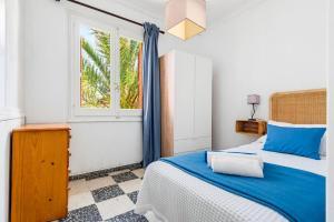 a bedroom with a bed and a window at Las Belisas in Arenal d'en Castell +46 photos