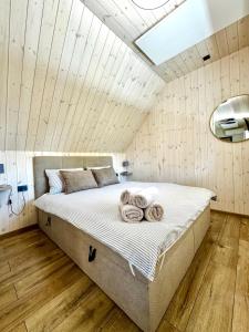 a bedroom with a large bed with towels on it at G17-1 Palanga in Palanga