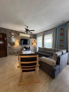 a living room with a couch and a chair at Florence Chalet in Marina Wadi Degla Ain Sokhna - Ground floor with 360 Sqm with Private Garden in Ain Sokhna