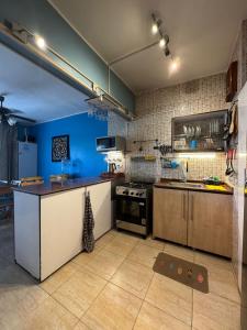 a kitchen with a stove and a blue wall at Florence Chalet in Marina Wadi Degla Ain Sokhna - Ground floor with 360 Sqm with Private Garden in Ain Sokhna