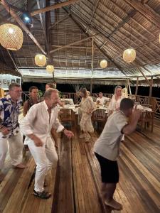 a group of people dancing in a room at Diana Lodge in Ankify