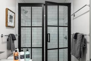 a shower with a glass door in a bathroom at Stylish Birmingham Loft + Rooftop Lounge in Birmingham