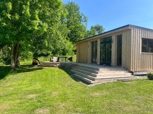 a small wooden building with a grassy yard at Pagalėlių namai in Voveriai +26 photos