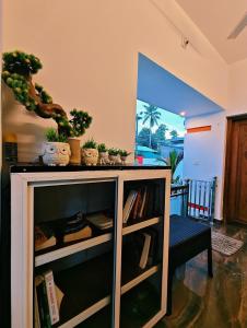 a book shelf with some plants on top of it at Phoenix homestay in Varkala