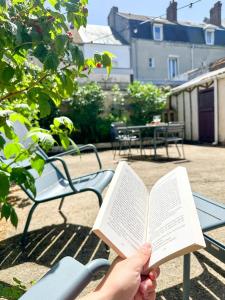 a person reading a book on a bench at Les Soupières in Fécamp