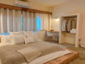 a bedroom with a large bed and a desk at Thara Coco Villa - Boutique Luxury In Srithanu in Hinkong +2 photos