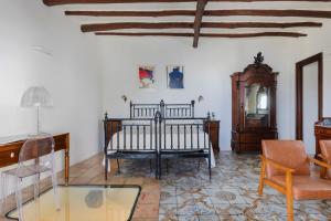 a room with a bed and a table and a mirror at Boutique Hotel I Cinque Balconi in Santa Marina Salina