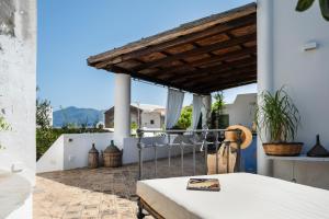 a patio with a table and a roof at Boutique Hotel I Cinque Balconi in Santa Marina Salina
