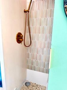 a shower with a shower head in a bathroom at Boho luxury caravan in Kisapáti