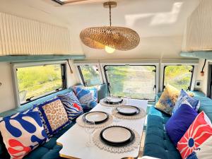 a living room with a couch and a table at Boho luxury caravan in Kisapáti