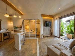 a living room with a kitchen and a room with a couch at Thara Coco Villa - Boutique Luxury In Srithanu in Hinkong