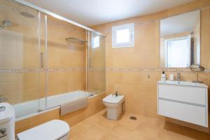 a bathroom with a toilet and a shower and a sink at MarLau Breeze in Mojácar