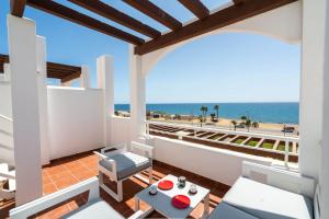 a balcony with a view of the beach at MarLau Breeze in Mojácar