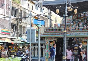 a group of people walking in front of a market at Home Base Hostel in Bangkok