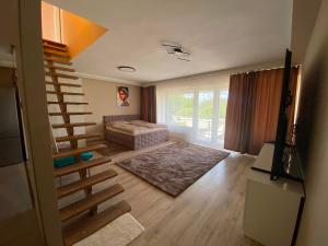 a living room with a staircase and a bed at Garden Spa Resort in Budapest