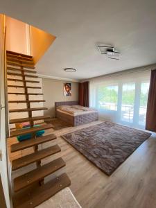 a living room with a staircase and a bed at Garden Spa Resort in Budapest +111 photos