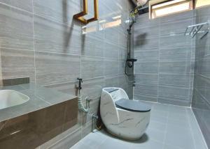 a bathroom with a toilet and a sink at Aurora Nungwi in Nungwi +84 photos