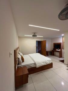 a bedroom with a bed and a tv in it at Hotel LIORA GRAND in Bangalore