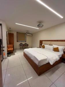 a bedroom with a large bed and a screen at Hotel LIORA GRAND in Bangalore