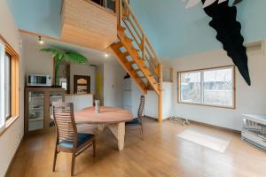a kitchen and dining room with a wooden table and chairs at Kussharoko Artemina Deer in Teshikaga