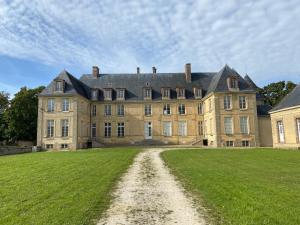 a large house with a grass field in front of it at Studio Château de Passy in Passy