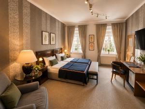 a bedroom with a bed and a living room at Pension & Restaurant Zu den Linden Radebeul in Radebeul