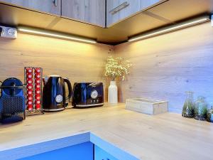a kitchen counter with two toasters on a wooden counter top at Stella Plage, Studio Vert et Mer in Cucq
