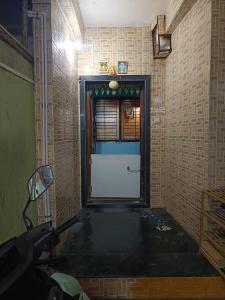 a room with a door in a brick wall at Swami Inn Lodging in Trimbak