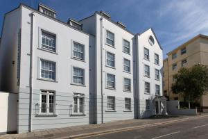 a white building on the side of a street at SACO Jersey - Merlin House in Saint Helier Jersey