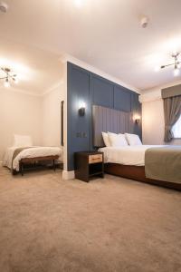 a large bedroom with two beds and a table at Lion Hotel in Worksop +87 photos