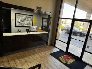 a lobby with a counter and a view of a parking lot at Super 8 by Wyndham Conway in Conway