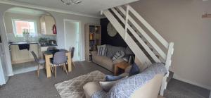 a living room with a couch and a table at The cosy house in Corton