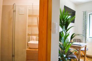 a bathroom with a shower and a sink and a table at Weingut Primus Südsteiermark in Spielfeld +71 photos