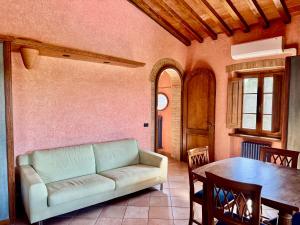 a living room with a couch and a table at Bed & Breakfast Casale Gregoriano in San Gimignano