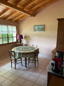 a kitchen with a table and chairs in a room at Château de Villeron in Savigny-en-Revermont