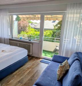 a bedroom with a bed and a large window at Fewo Marek in Gaienhofen