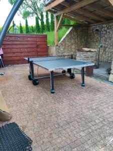 a ping pong table sitting on a patio at Alpina in Krynica Zdrój