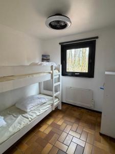 two bunk beds in a room with a window at Cabana 16 in Petit Mesnil