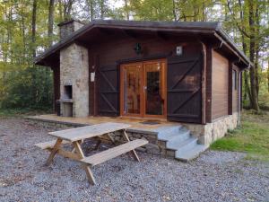 a cabin with a picnic table in front of it at Cabana 16 in Petit Mesnil