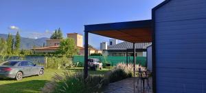 a house with a car parked in a yard at Cantal Tiny Houses in Salta