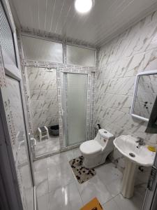 a bathroom with a toilet and a sink at Azure Coast Residence in Mostaganem