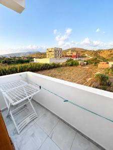 a white shelf on a balcony with a view at Azure Coast Residence in Mostaganem